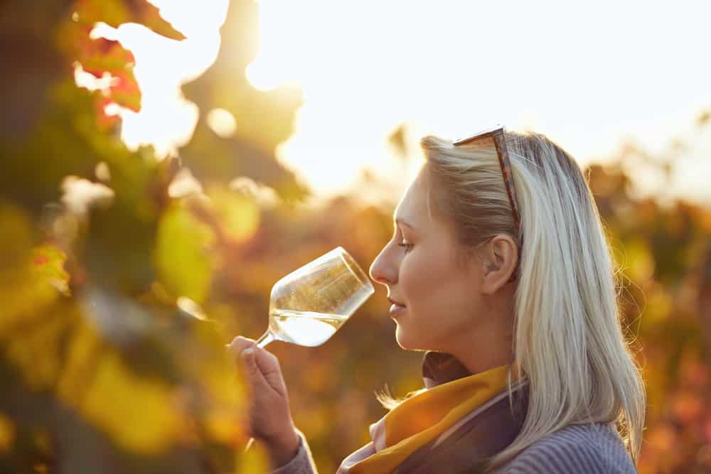 Woman wine tasting during the fall at Maryland wineries on the Eastern Shore