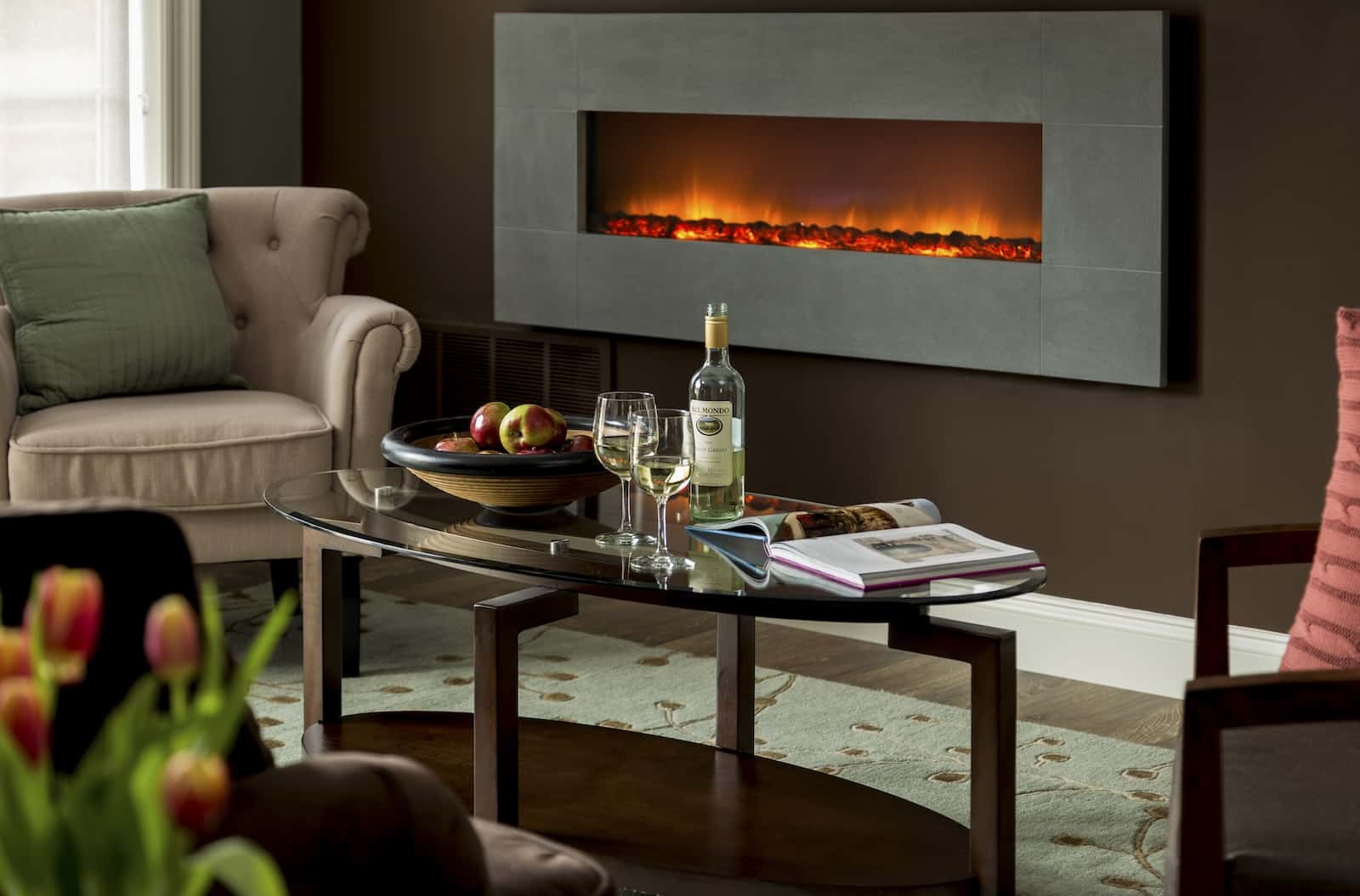 How To Spend the Day in the Chestertown Historic District 2 A fireplace by a coffee table with wine at a cozy Maryland Bed and Breakfast.