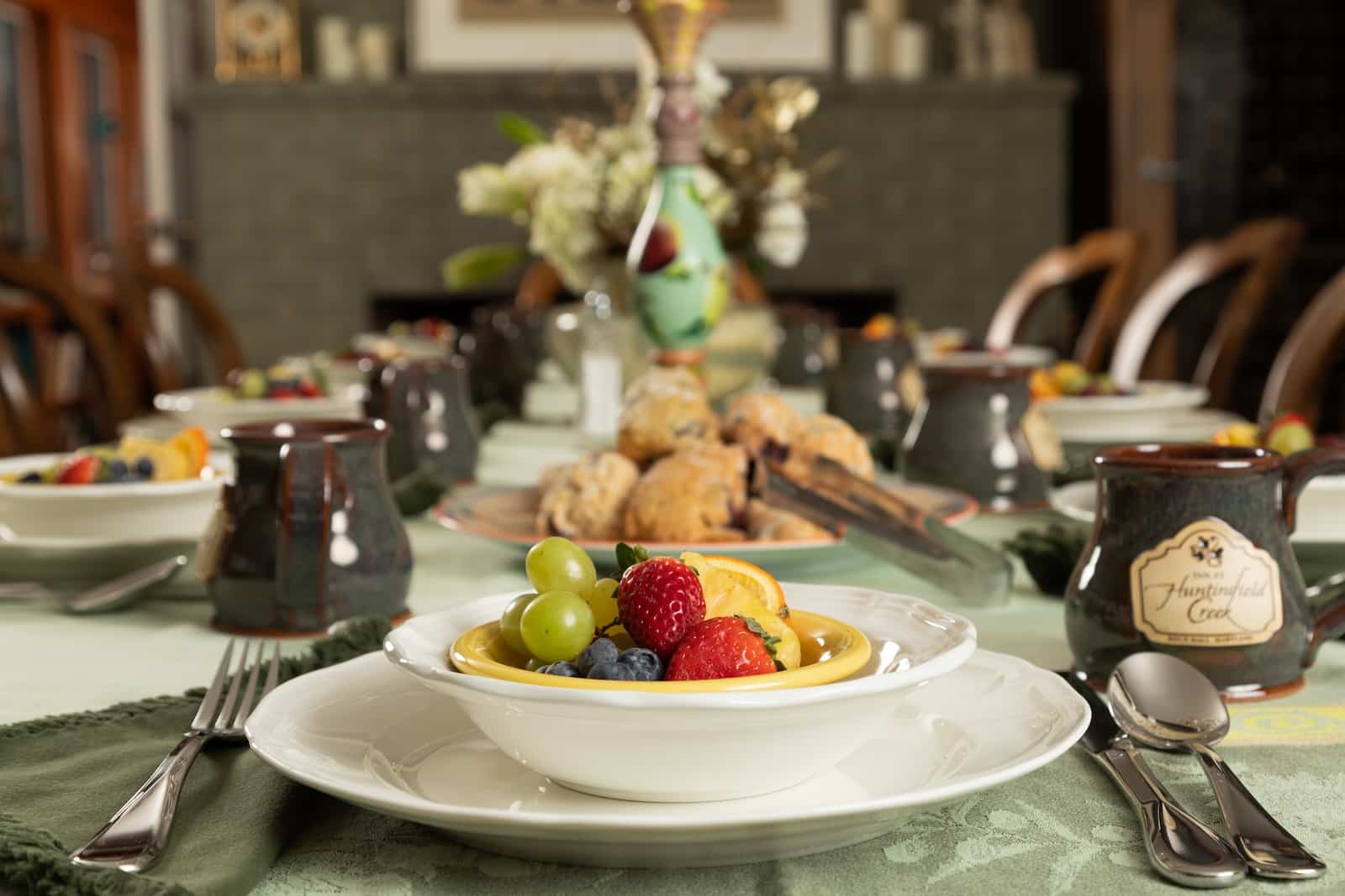Things to do in Rock Hall MD This Fall 2 A bowl of fruit at a tablescape with coffee and morning pastries at the best Bed and Breakfast in Maryland.