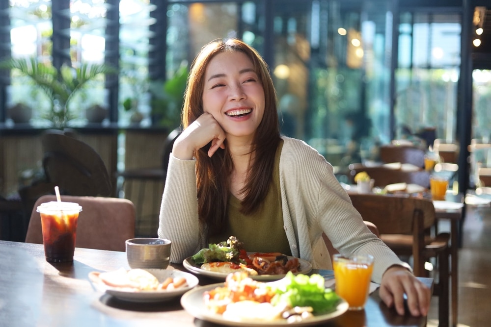 An Asian woman enjoying one of the best restaurants in Rock Hall, MD