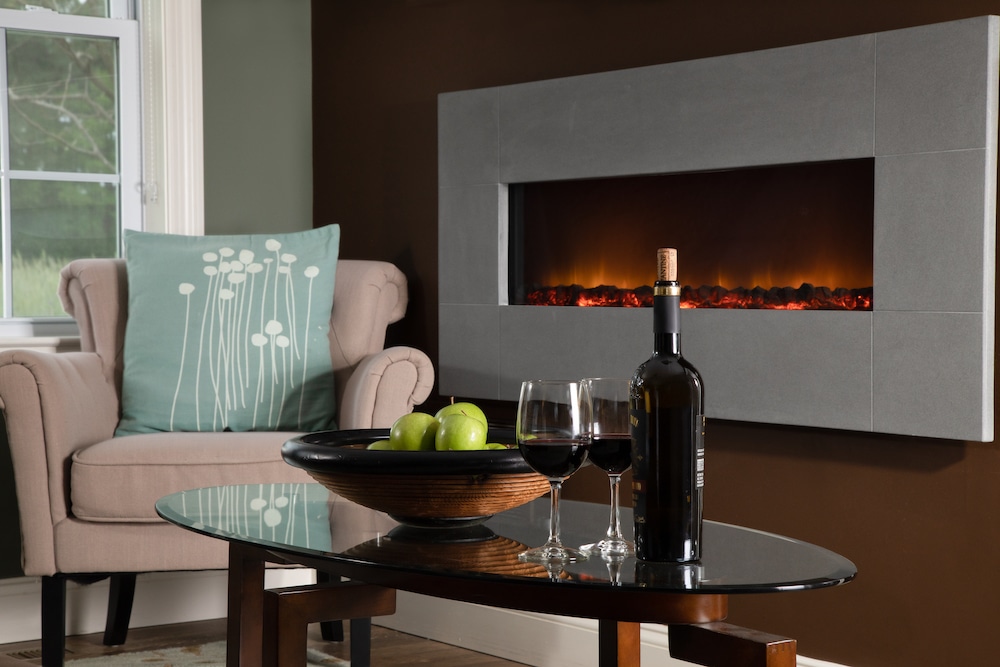 glasses of wine by the fire during cozy romantic getaways in Maryland in our Rock Hall MD Cottages