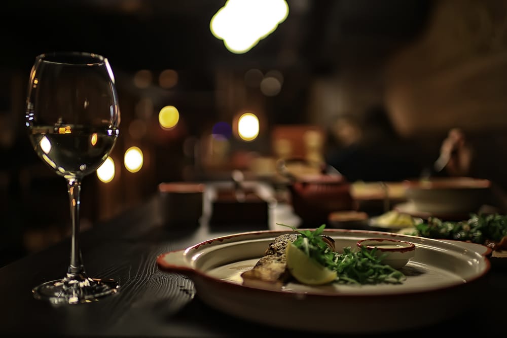 Plate setting with wine at one of the most romantic Rock Hall, MD Restaurants