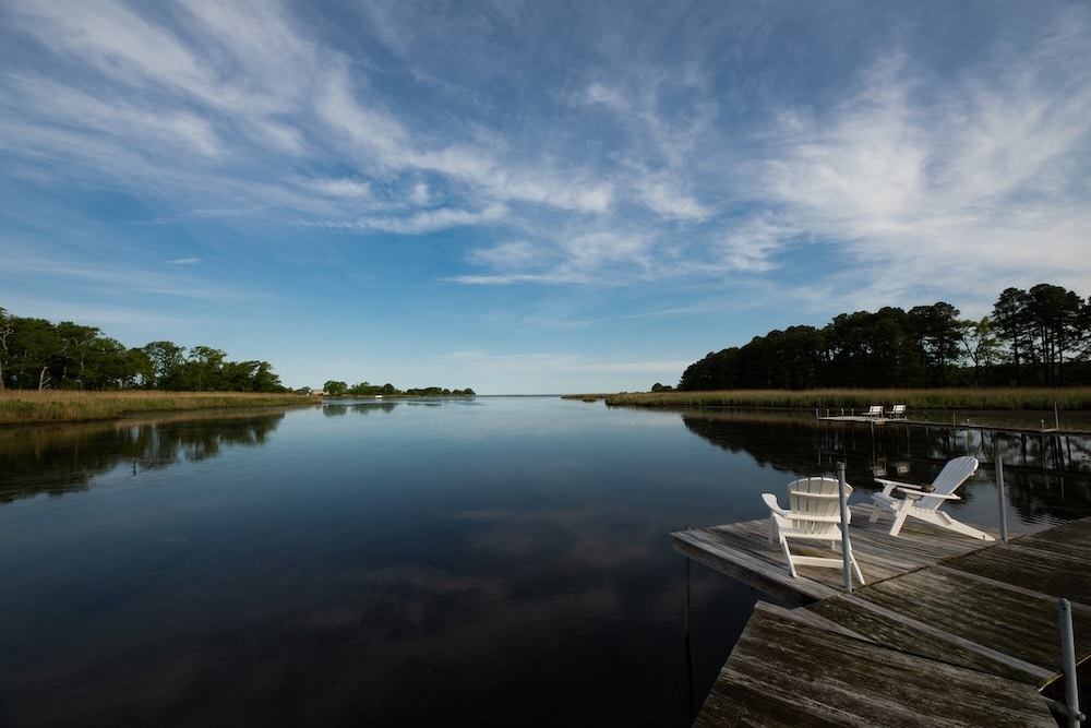 The Best Chesapeake Bay Beaches in Maryland 5 two adirondack chairs by the water at our Rock Hall Bed and Breakfast on the Chesapeake Bay