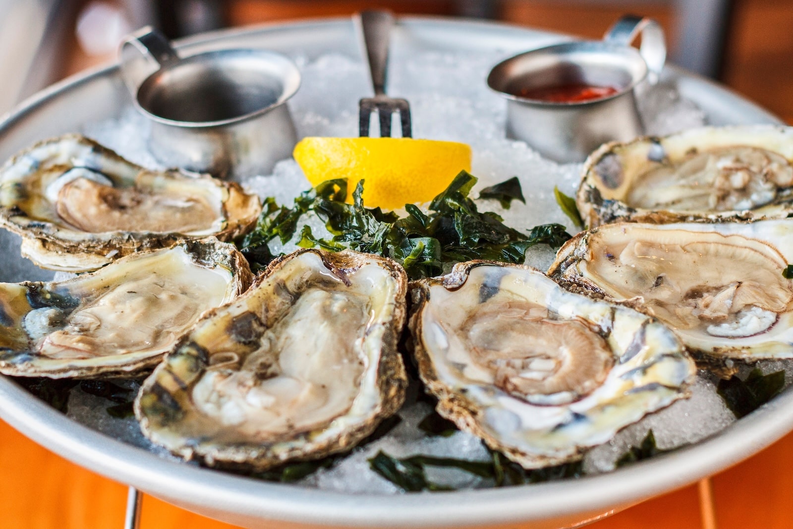 A plate of oysters, a lemon, and cocktail sauce on the Maryland Crab and Oyster Trail.