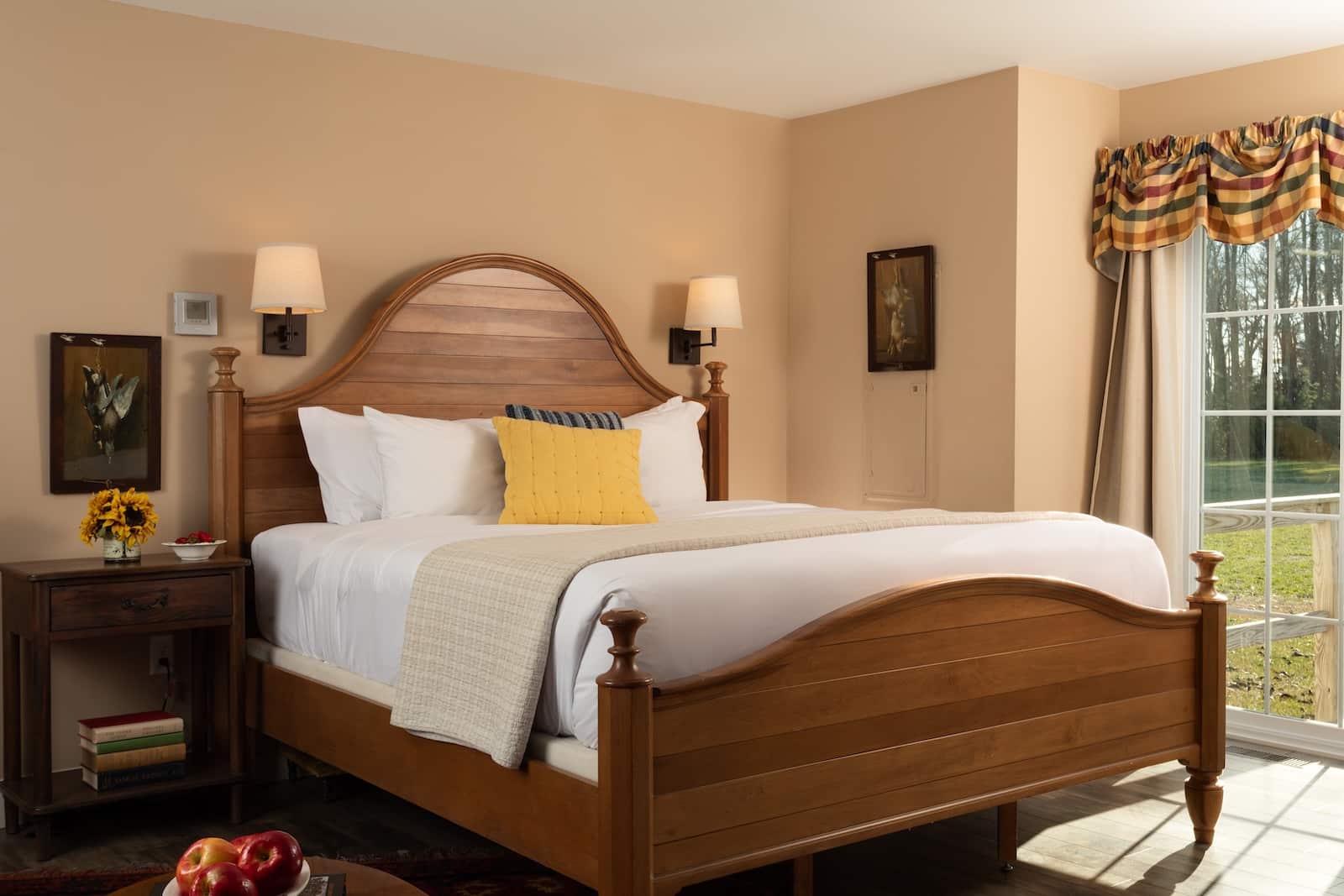 A First-Timer's Guide to Kent County, Maryland 2 A bed by a window with lamps and a night stand at the best Bed and Breakfast in Maryland.